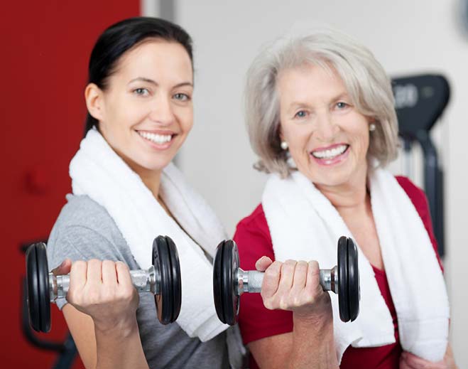 two ladies holding weights